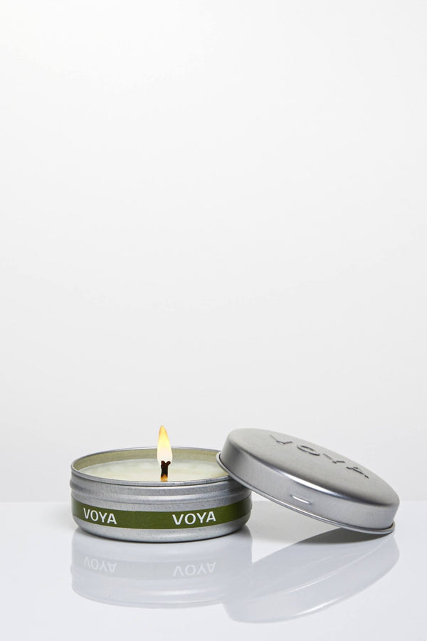 Voya African Lime and Clove Mini Scented Travel Candle lit with flame