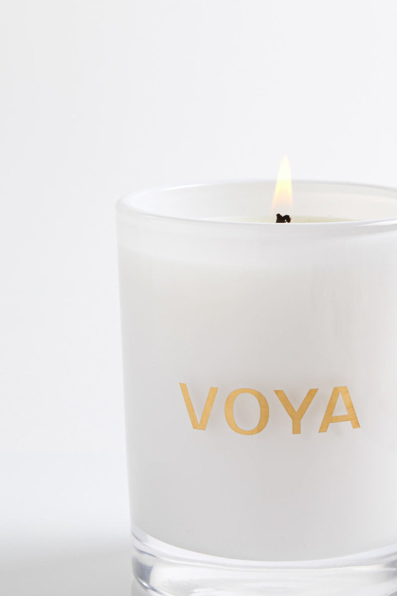 VOYA Skincare USA Eucalyptus, Rosemary, and Lime Luxury Essential Oil Candle, lit with flame.